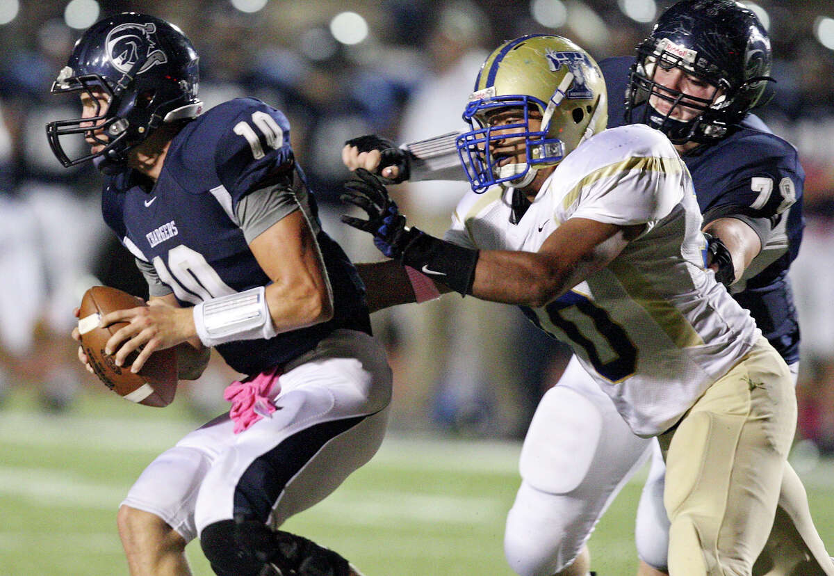 Boerne Champion's Kyle Poeske (left) looks for room around Kerrville Tivy's Jesus Hernandez as Boerne Champion's Ryan Koch moves in on the play during first half action Friday Oct. 12, 2012 at Boerne Independent School District Stadium in Boerne, TX.