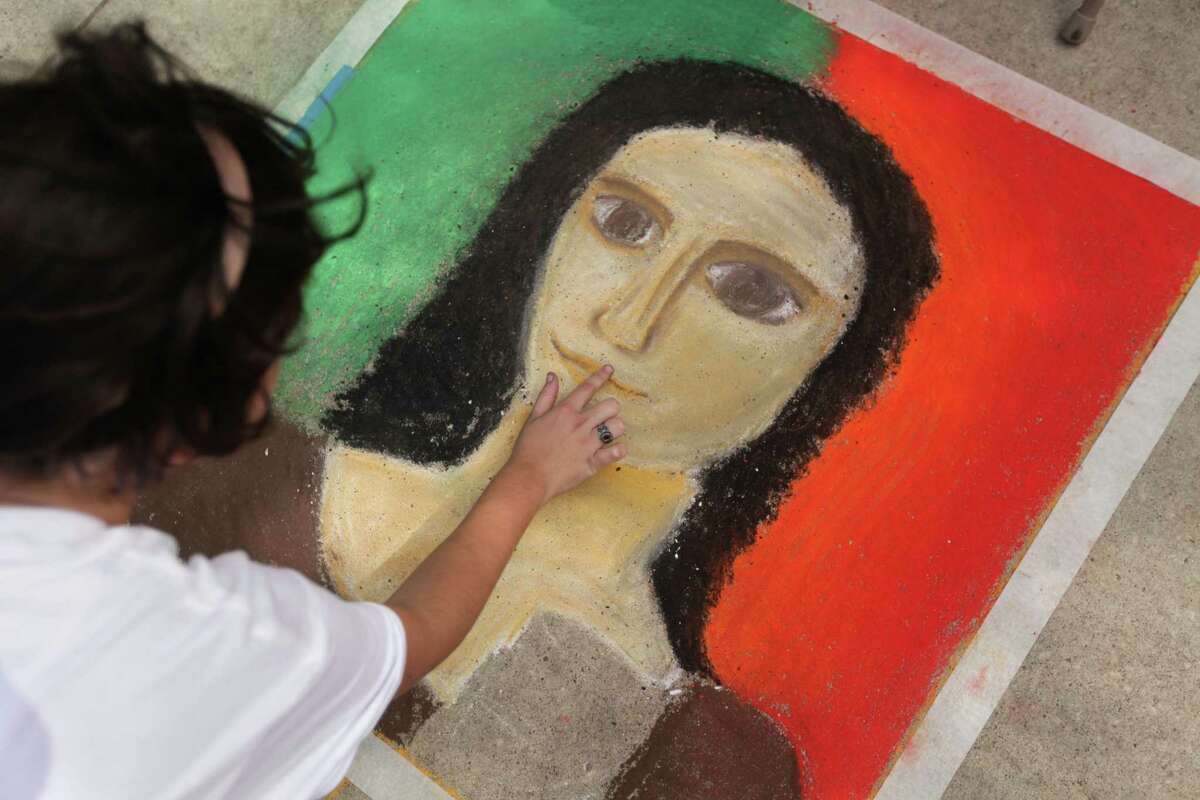 Abigail Bacilla, 17, of Incarnate Word Academy, participates in the Chalk Art contest by sketching Leonardo da Vinci-inspired portraits during the Houston Italian Festival.