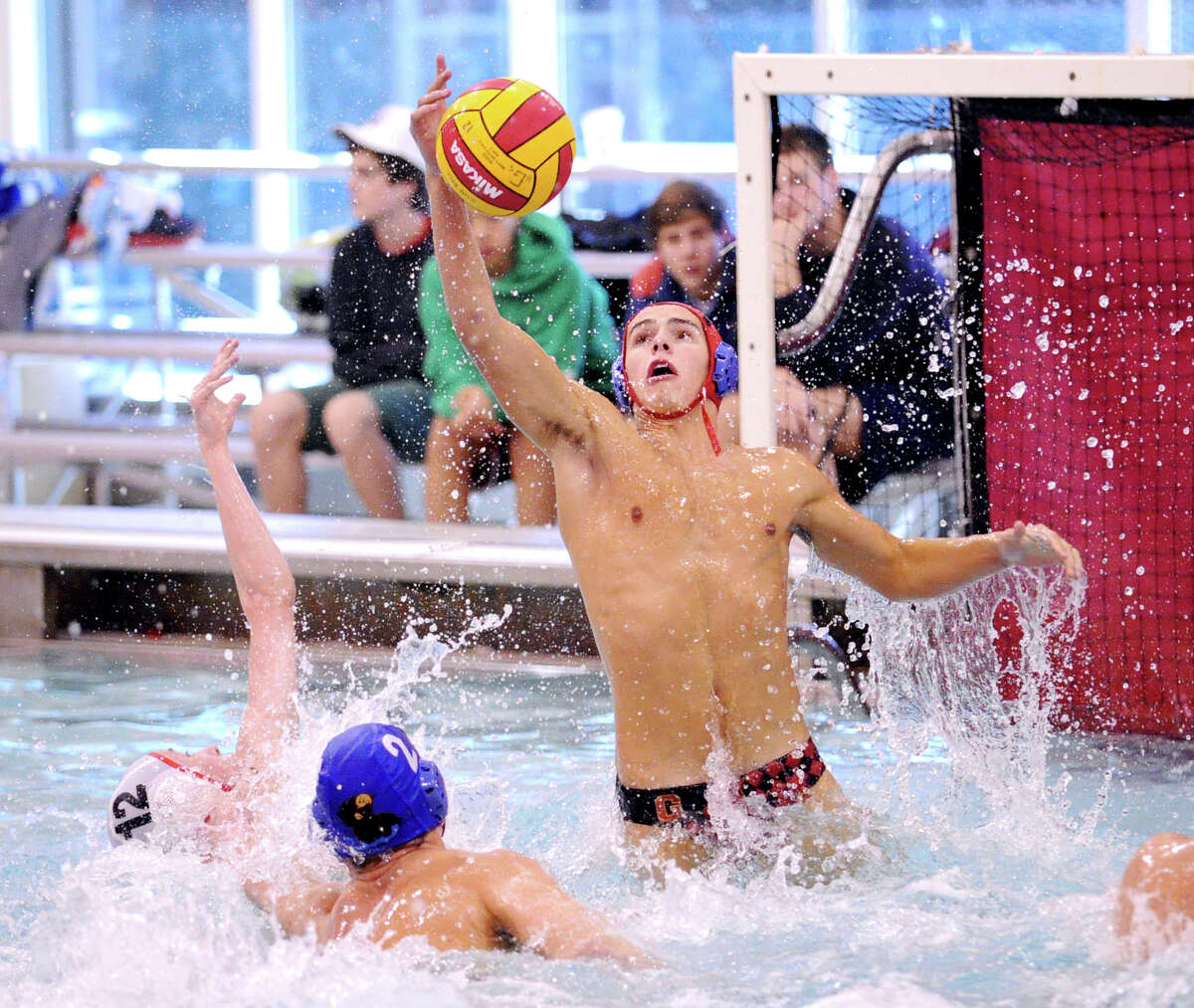 Greenwich High School water polo goalie Steven Michaud grabs a deflected shot in front of the goal as teammate Will Klingner # 2 defends against Thomas Savage # 12 of Lawrenceville during the Cardinal Water Polo tournament at Greenwich High School, Saturday afternoon, Oct. 13, 2012.