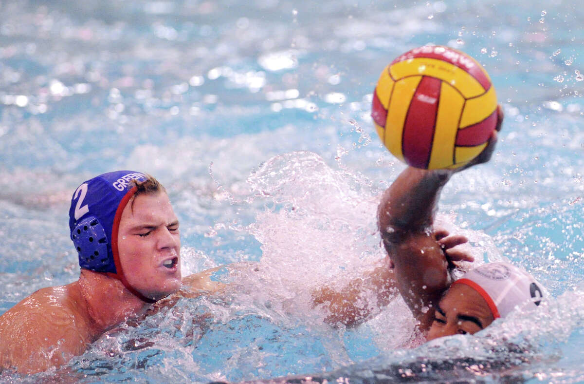 At left, Will Klingner # 2 of Greenwich defends against Jon Hayden # 9 of Lawrenceville during the Cardinal Water Polo tournament at Greenwich High School, Saturday afternoon, Oct. 13, 2012.