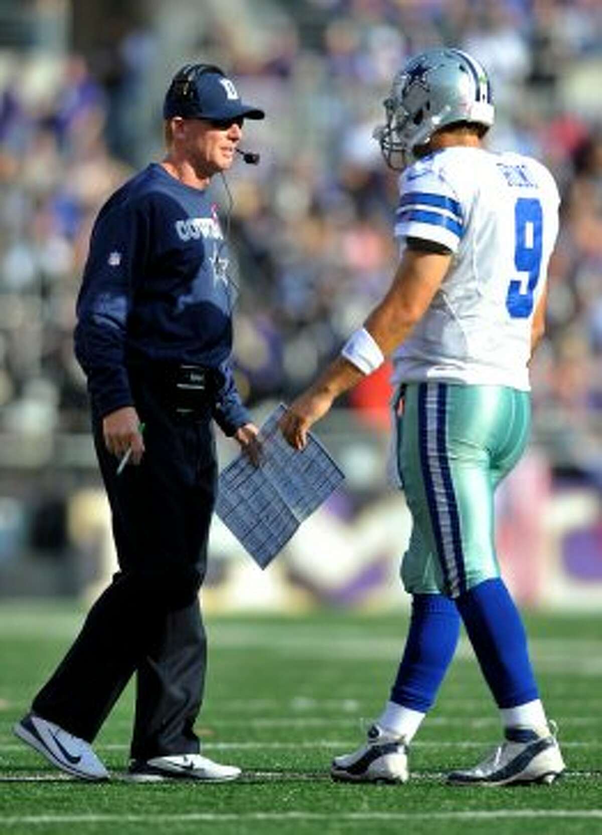 Cowboys coach Jason Garrett, left, speaks with quarterback Tony Romo in the second half against the  Ravens in Baltimore, Sunday, Oct. 14, 2012. (AP Photo/Gail Burton)
