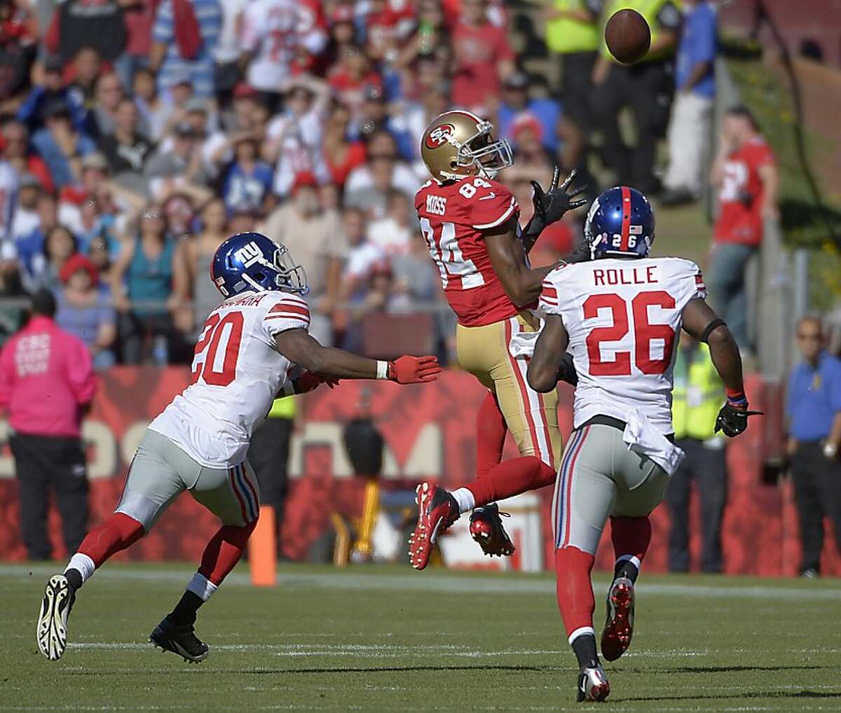San Francisco 49ers wide receiver Randy Moss (84) catches a pass over New York Giants cornerback Prince Amukamara (20) and free safety Antrel Rolle (26) during the third quarter of an NFL football game in San Francisco, Sunday, Oct. 14, 2012. (AP Photo/Mark J. Terrill)