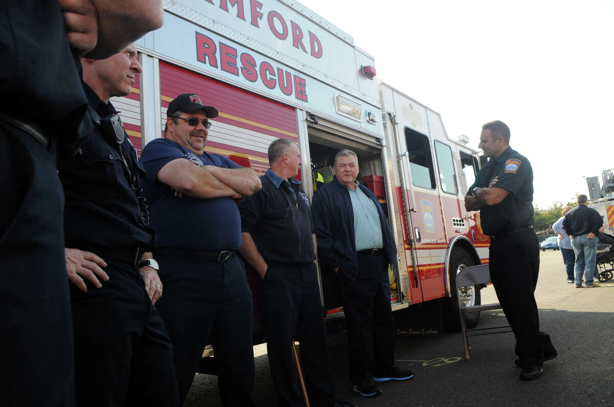 Stamford Fire and Rescue firefighters from left, Paul Tafoya, Dave Bocchetta, Tommy Gibbons, Stamford Board of Representative Ralph Loglisci and firefighter Joe Maida discuss emergency response as elected officials get a close up look at the Stamford firefighters workflow at the annual Stamford Professional Firefighters Association's Fire Operations Day at the Chief Charles McRedmond Fire Training Center in Stamford, Conn., Oct. 14, 2012.
