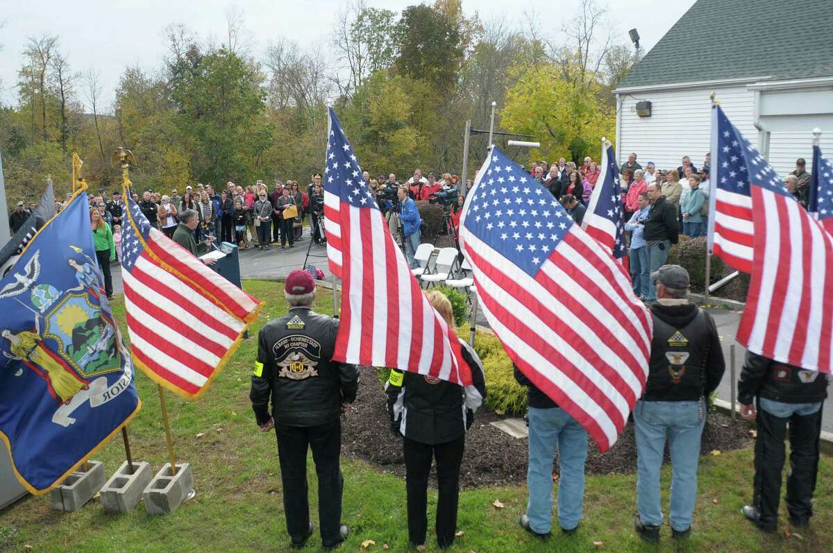 Members of the Patriot Guard Riders hold flags during a ceremony to celebrate the naming of the Route 20 Bridge in the town of Nassau on Sunday, Oct. 14, 2012. The bridge was named the Staff Sergeant Derek Farley Memorial Bridge. Derek Farley was an Army explosives ordnance disposal technician who was deployed in 2009 as team leader to Afghanistan with the 702nd EOD Company. Farley died in Afghanistan on Aug. 17, 2010. (Paul Buckowski / Times Union)