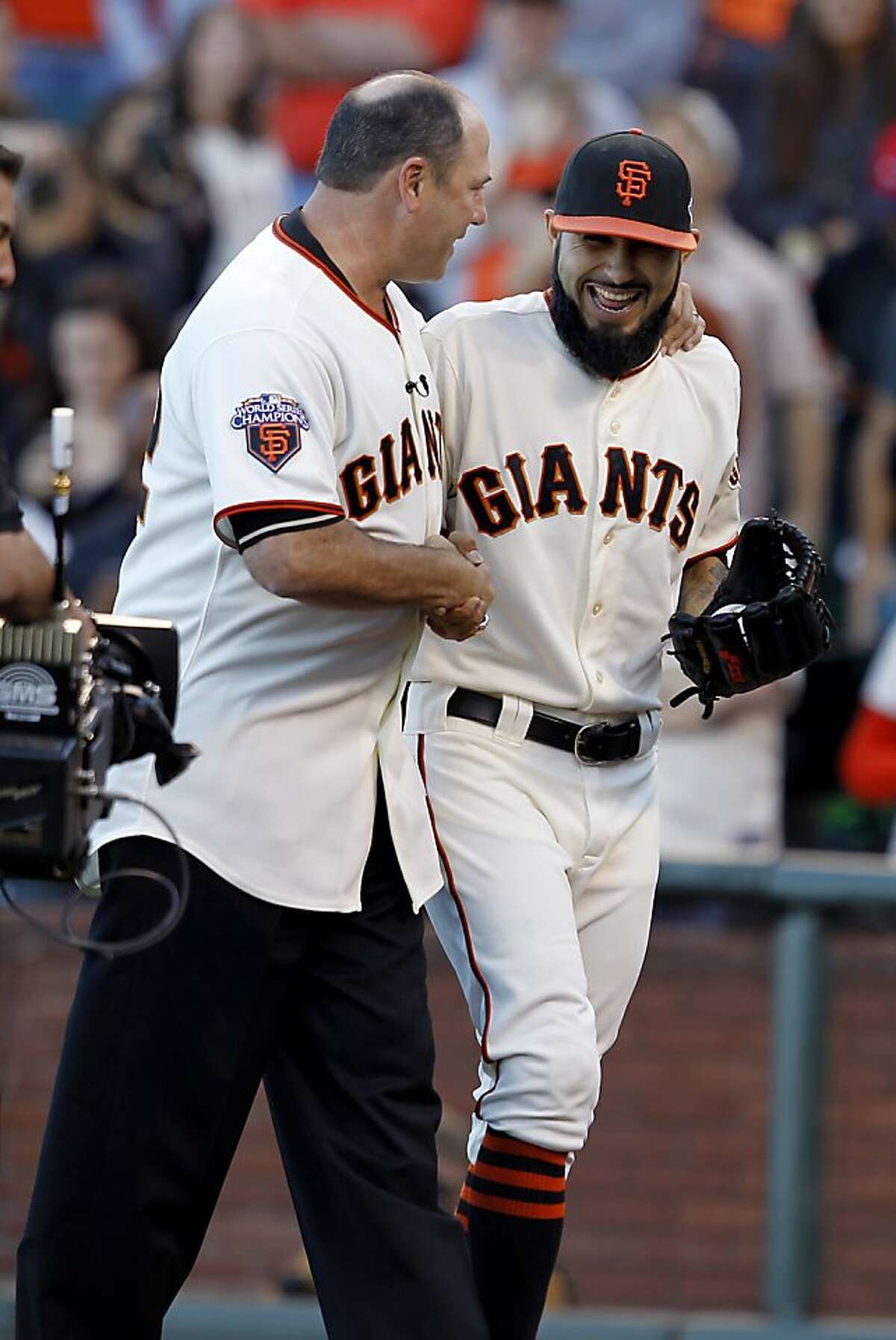Will Clark (left) threw out the first pitch to pitcher Sergio Romo, they joked about it afterward. The San Francisco Giants lost 6-4 to the St. Louis Cardinals in the first game of the league championship series Sunday Octboer 14, 2012 at AT&T park.