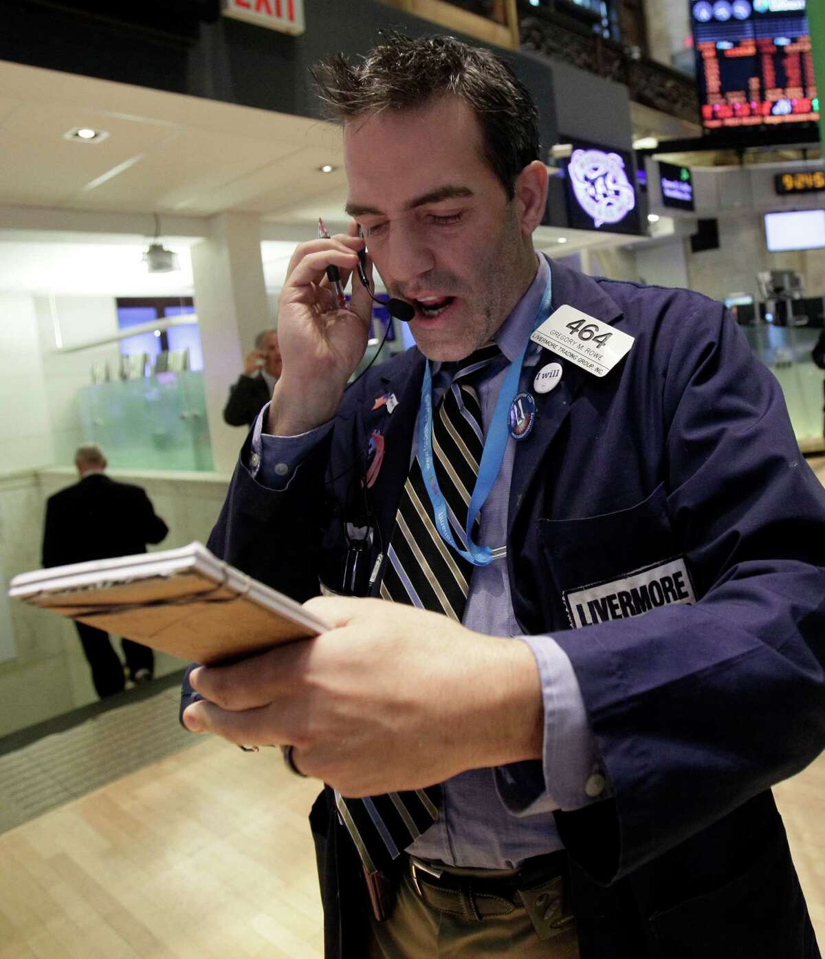 Trader Gregory Rowe works on the floor of the New York Stock Exchange Monday, Oct. 15, 2012.