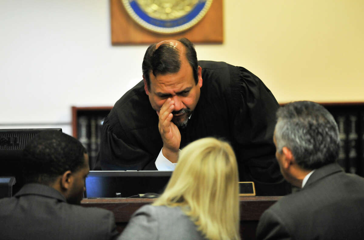 Judge Ron Rangel of the 379 District Court speaks to defense attorneys David Henderson (left) Jan Ishy (center) and defense attorney Joel Perez as the sentencing phase of convicted capital murderer James Morrison's trial begins Monday, Oct. 15, 2012.