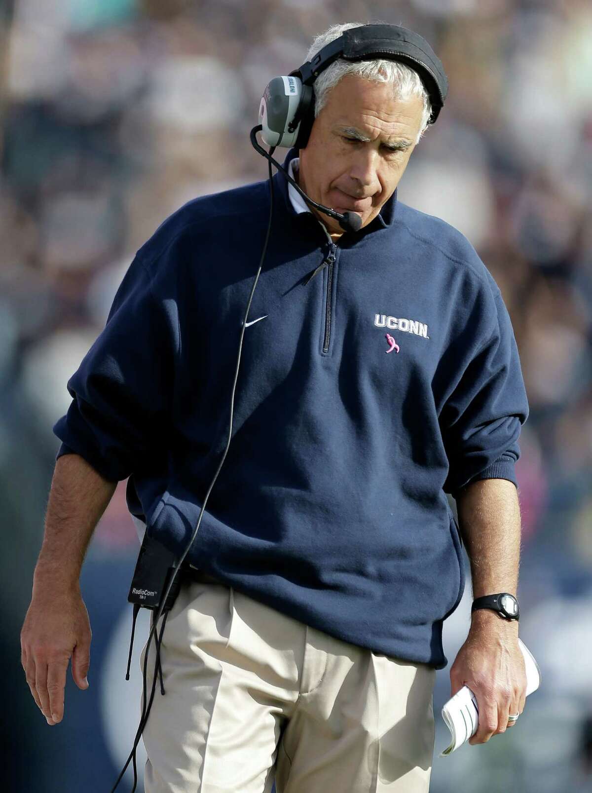Connecticut head coach Paul Pasqualoni walks on the sidelines in the fourth quarter of an NCAA college football game against Temple in East Hartford, Conn., Saturday, Oct. 13, 2012. Temple won 17-14 in overtime. (AP Photo/Michael Dwyer)