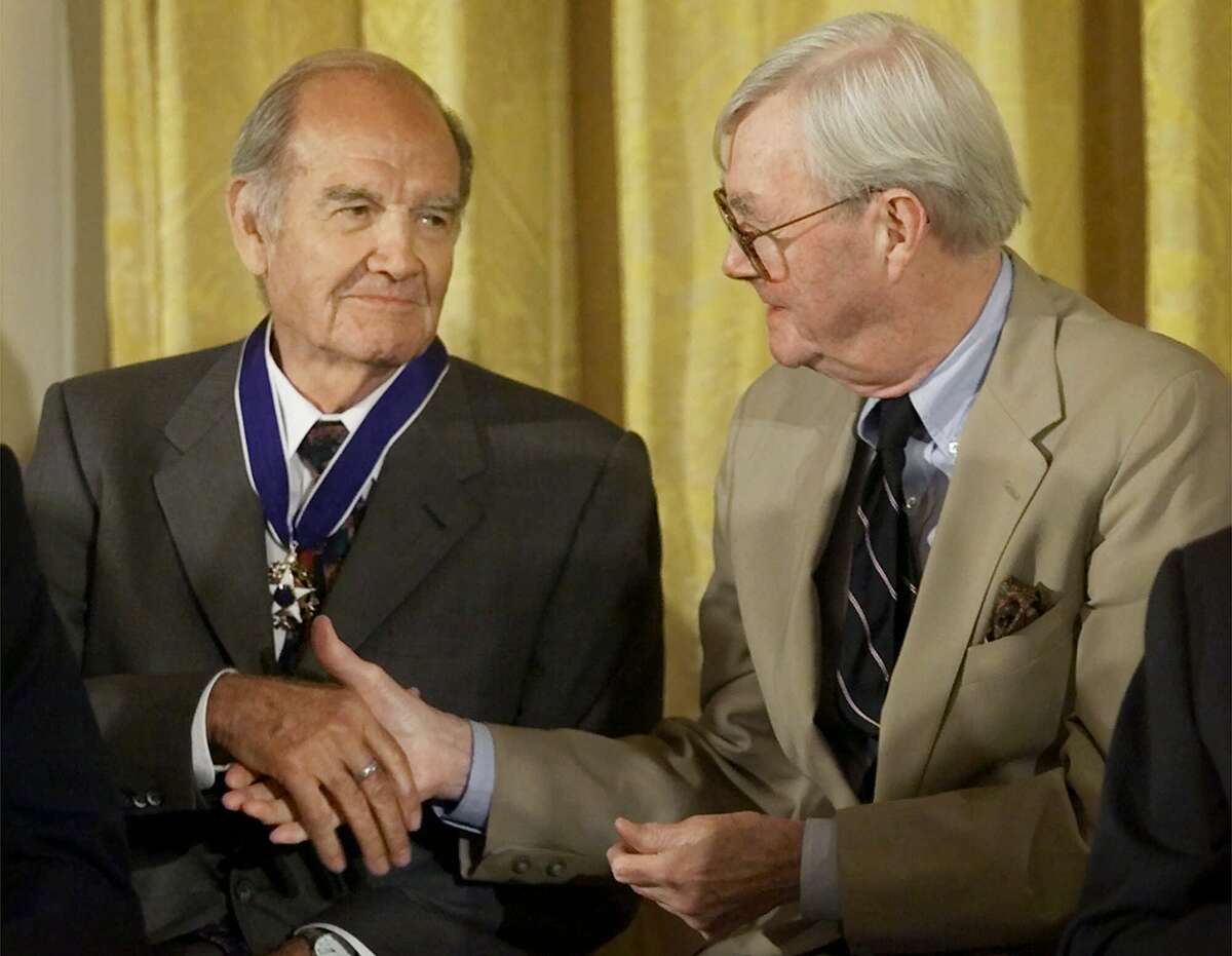 George McGovern, left, receives a handshake from fellow Presidential Medal of Freedom recipient Sen. Daniel Patrick Moynihan (D-NY), during ceremonies in the East Room of the White House, Wednesday, Aug. 9, 2000 in Washington, D.C. (AP Photo/Pablo Martinez Monsivais)