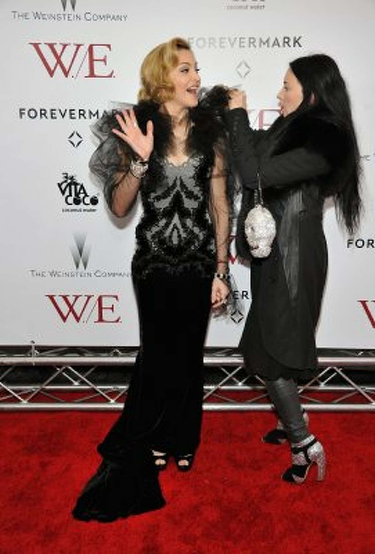 Madonna again, this time with an assistant helping her with her dress at the premiere of "W.E." in New York. (Theo Wargo / Getty Images)