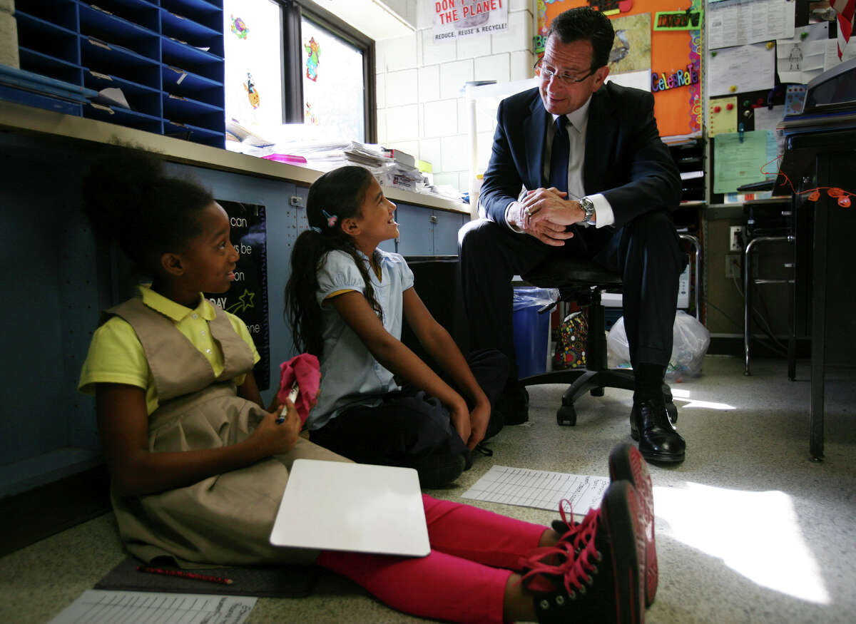 Fourth graders Kwajana Gooden, left, and Nayelis Perez, both 10, chat with Gov. Dannel P. Malloy during his visit to Curiale School in Bridgeport on Tuesday, October16, 2012.