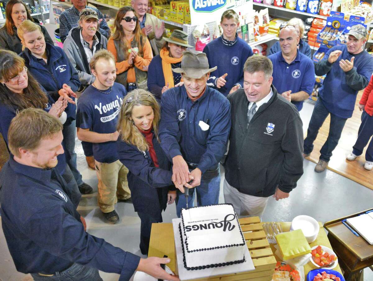 Store owners, from left, John Young, Peggy Young and Jim Young, with Rep. Chris Gibson, at right, cut a cake during Young?s General Store in Prattsville's grand reopening Tuesday Oct. 16, 2012, following the store's destruction by Hurricane Irene. (John Carl D'Annibale / Times Union)