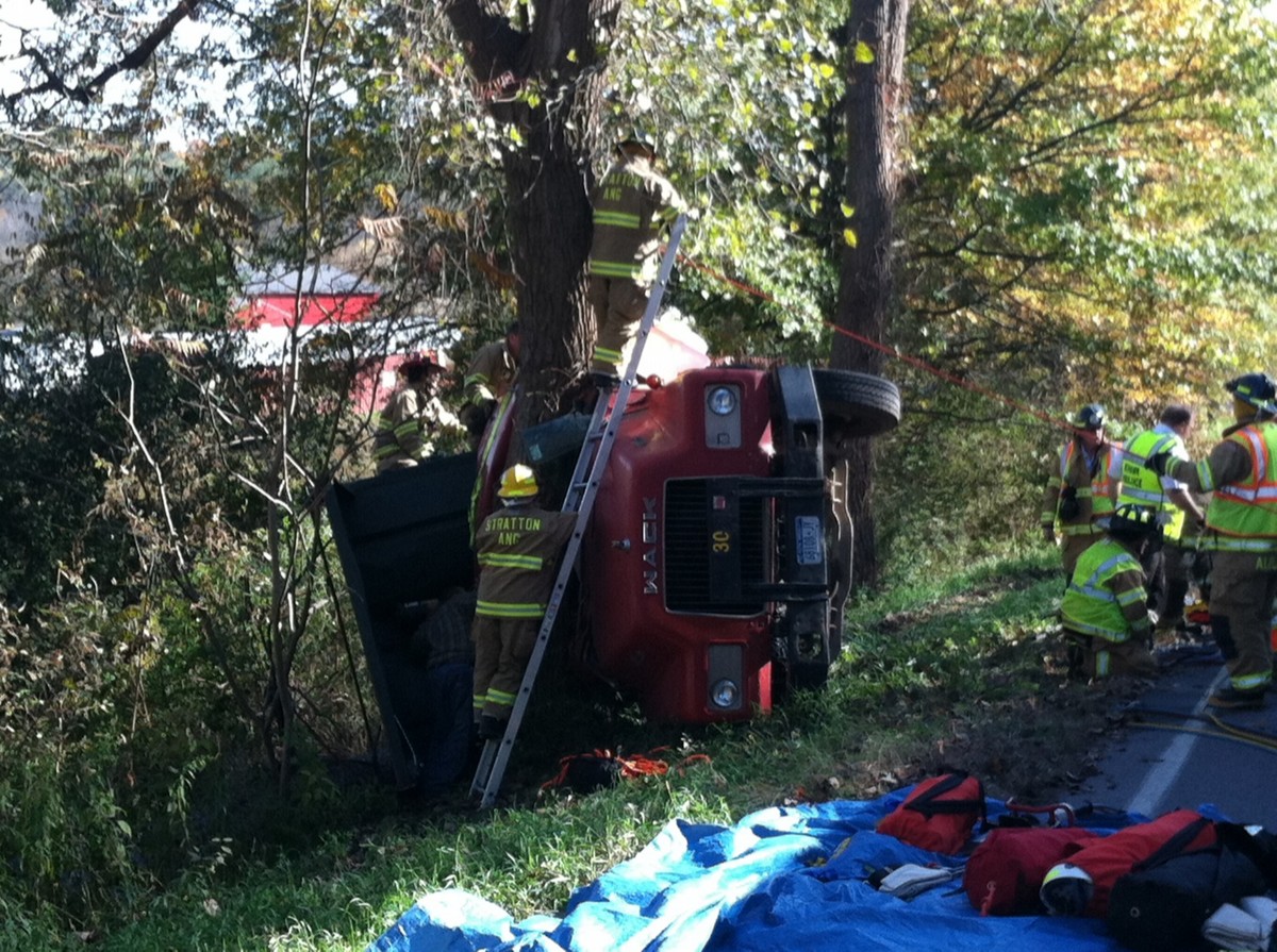 Driver freed from overturned truck