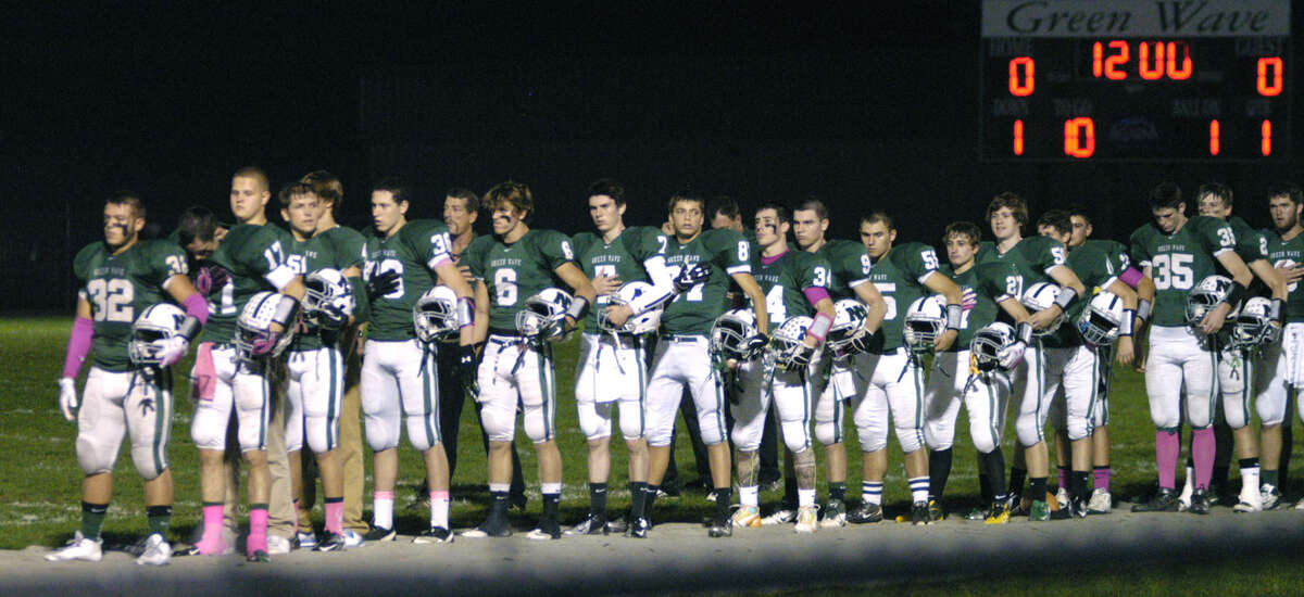 The Green Wave stands in respect to the Stars and Stripes during the NMHS band's playing of the Star Spangled Banner moments before New Milford High School football played visiting Pomperaug, Oct. 5, 2012