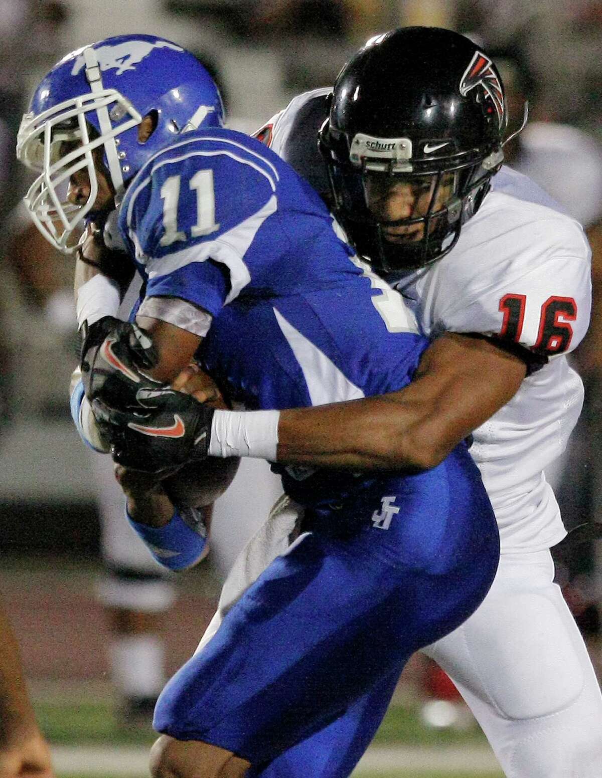 Stevens' Dominique Williamson, right, takes down John Jay's Josh Reynolds during a District 27-5A high school football game, Friday, Sept. 23, 2011, at Gustafson Stadium in San Antonio.