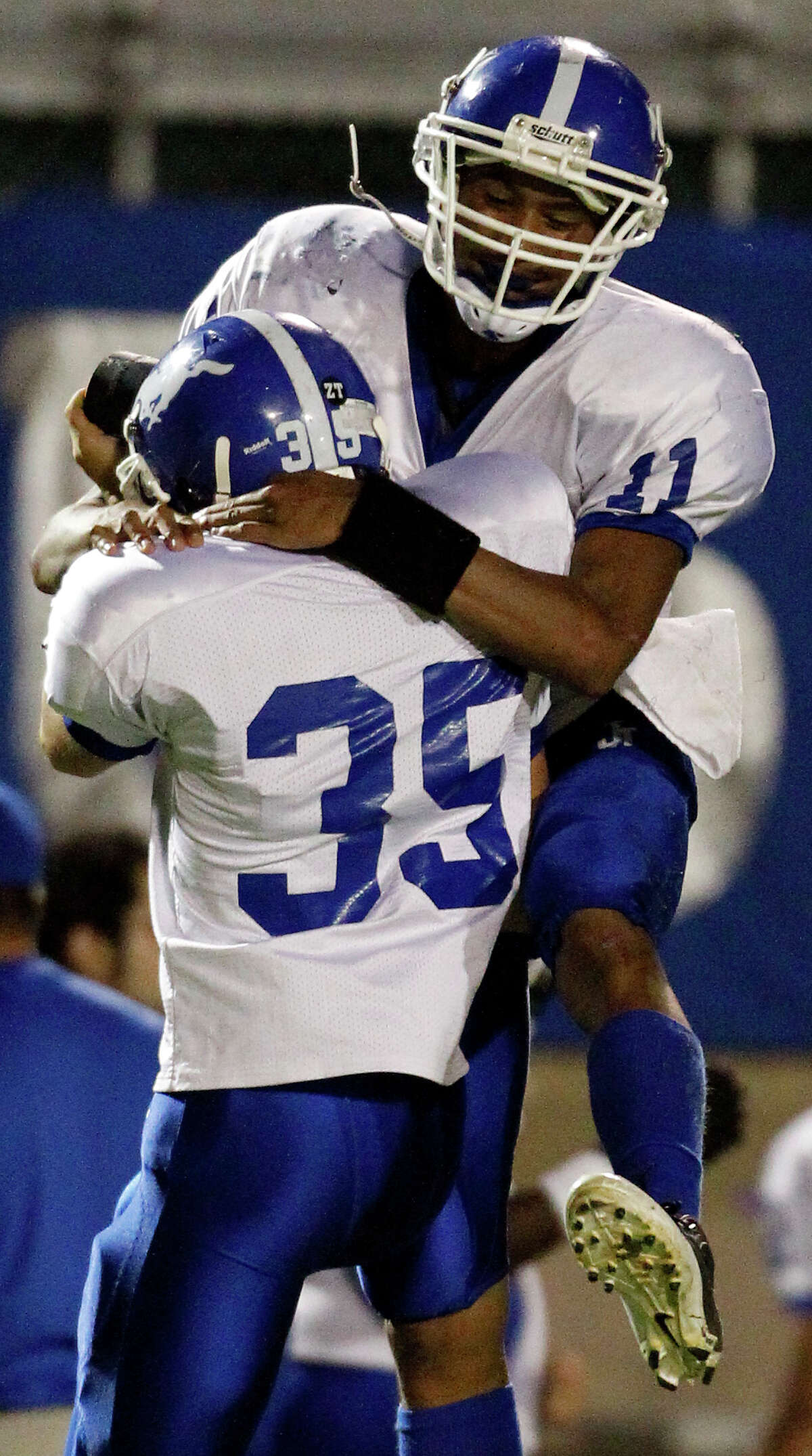 Jay's Josh Reynolds (11) celebrates with kicker Aaron Haston (35) after Reynolds recovered an onside kick during game action against O'Connor at Farris Stadium on Oct. 15, 2011. Jay won 34-27 in overtime.