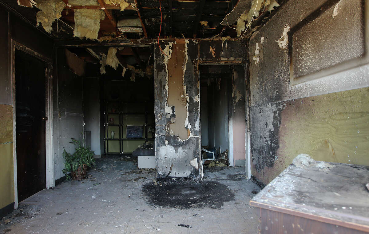 Seen through a broken window, this common room in the boarding home on Norfleet Street was burned during the fire that injured two residents. The blaze was believed to have been caused by a cigarette.