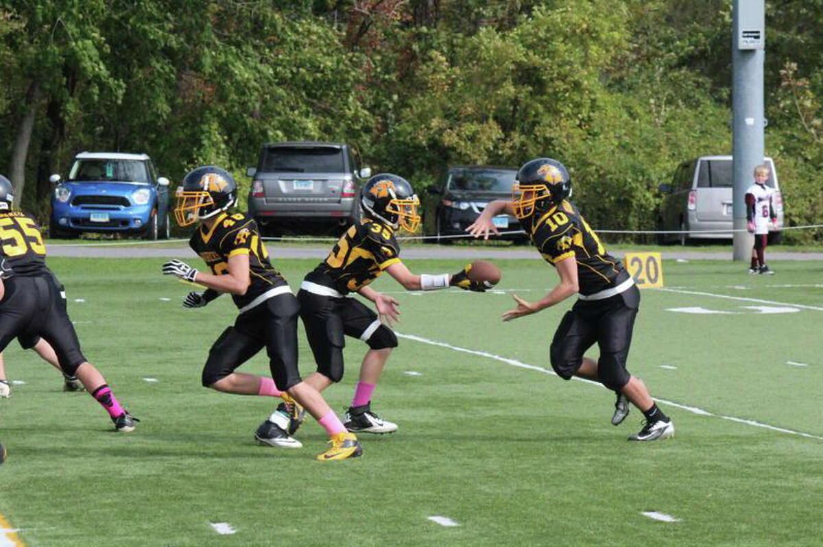 Glenville Mavericks quarterback Trystan Sarcone hands the ball off to James Budkins as Ian Pearson and Lachlan Rosato lead the way up front.