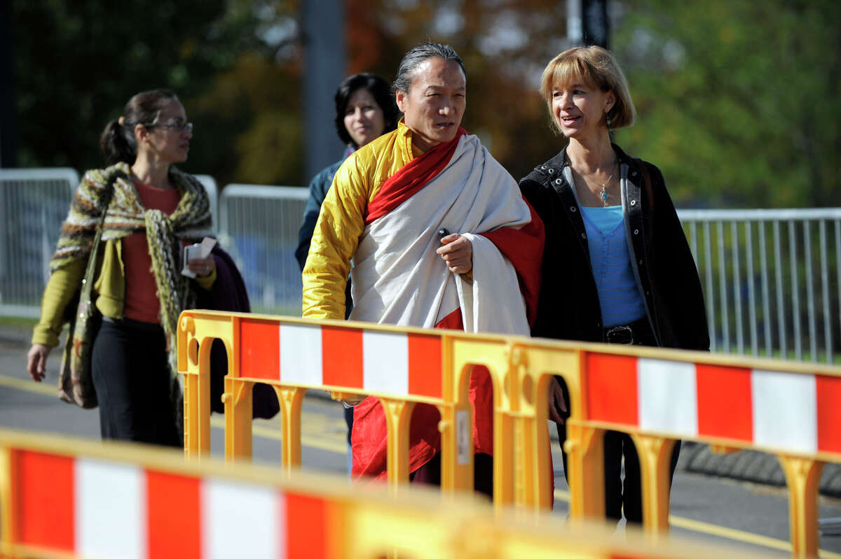 People arrive at the O'Neill Center at Western Connecticut State University Thursday morning for the first day of a two-day visit of the Dalai Lama, Oct. 18, 2012.