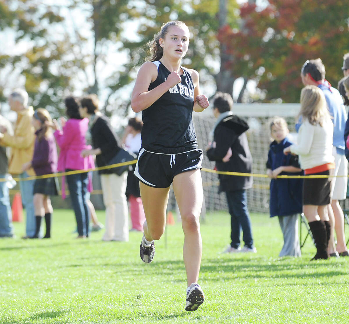 Fairfield-Warde High School runner Cate Allen finishes first during the FCIAC girls high school cross country championship at Waveny Park in New Canaan, Thursday afternoon, Oct. 18, 2012.