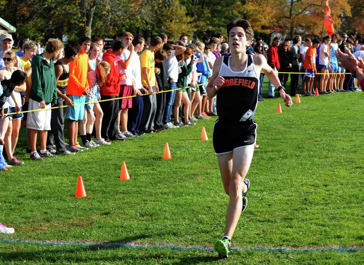 Ridgefield's Trevor Hopper crosses the finish line for second place, during boys FCIAC cross country action at Wavenly Park in New Canaan, Conn. on Thursday October 18, 2012.