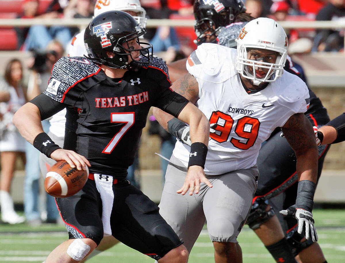 Texas Tech quarterback Seth Doege (7) looks for a receiver under pressure from Oklahoma State defensive tackle Richetti Jones (99) in the third quarter of an NCAA college football game in Lubbock, Texas, Saturday, Nov. 12, 2011. Oklahoma State won 66-6. (AP Photo/Sue Ogrocki)