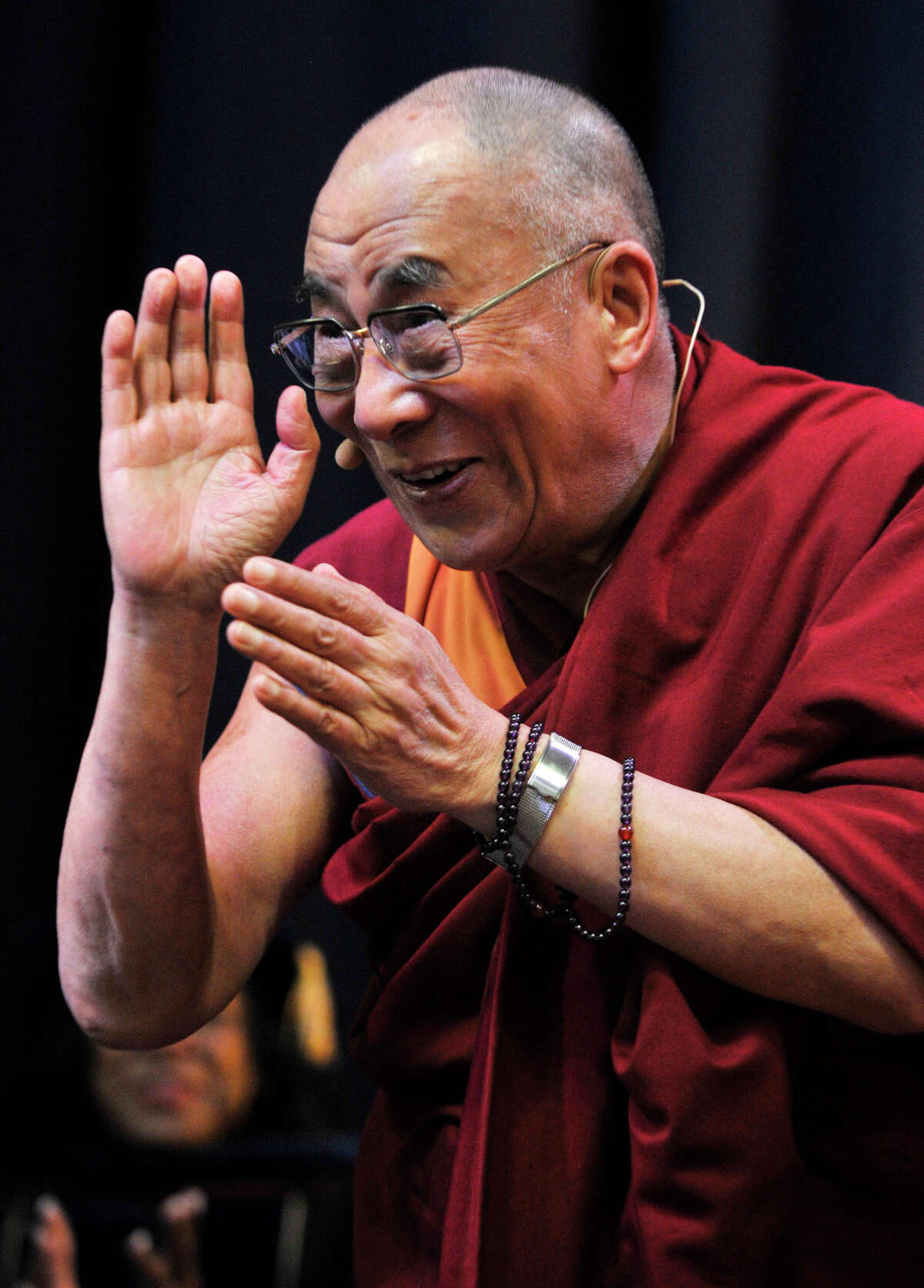 The Dalai Lama greets the crowd at the O'Neill Center before giving his speech "Advice for Daily Life" on Western Connecticut State University's westside campus in Danbury on Friday, Oct. 19, 2012.