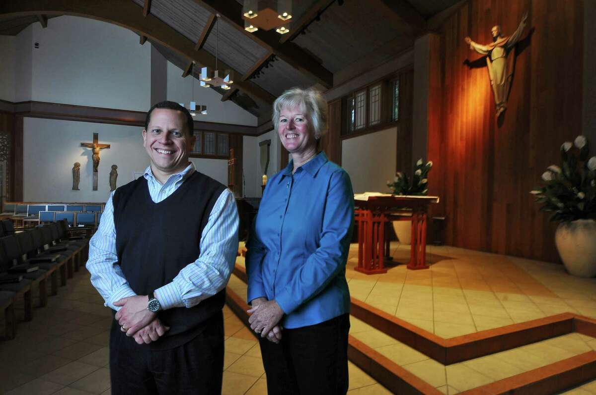 Trustees Larry Grimmer, left, and Sharon Koegl, right, stand in the sanctuary of the Saint Kateri Tekakwitha Parish on Tuesday Oct. 9, 2012 in Schenectady, NY. Prior to Oct. 21, the church was called Blessed Kateri Tekakwitha Parish. (Philip Kamrass / Times Union)