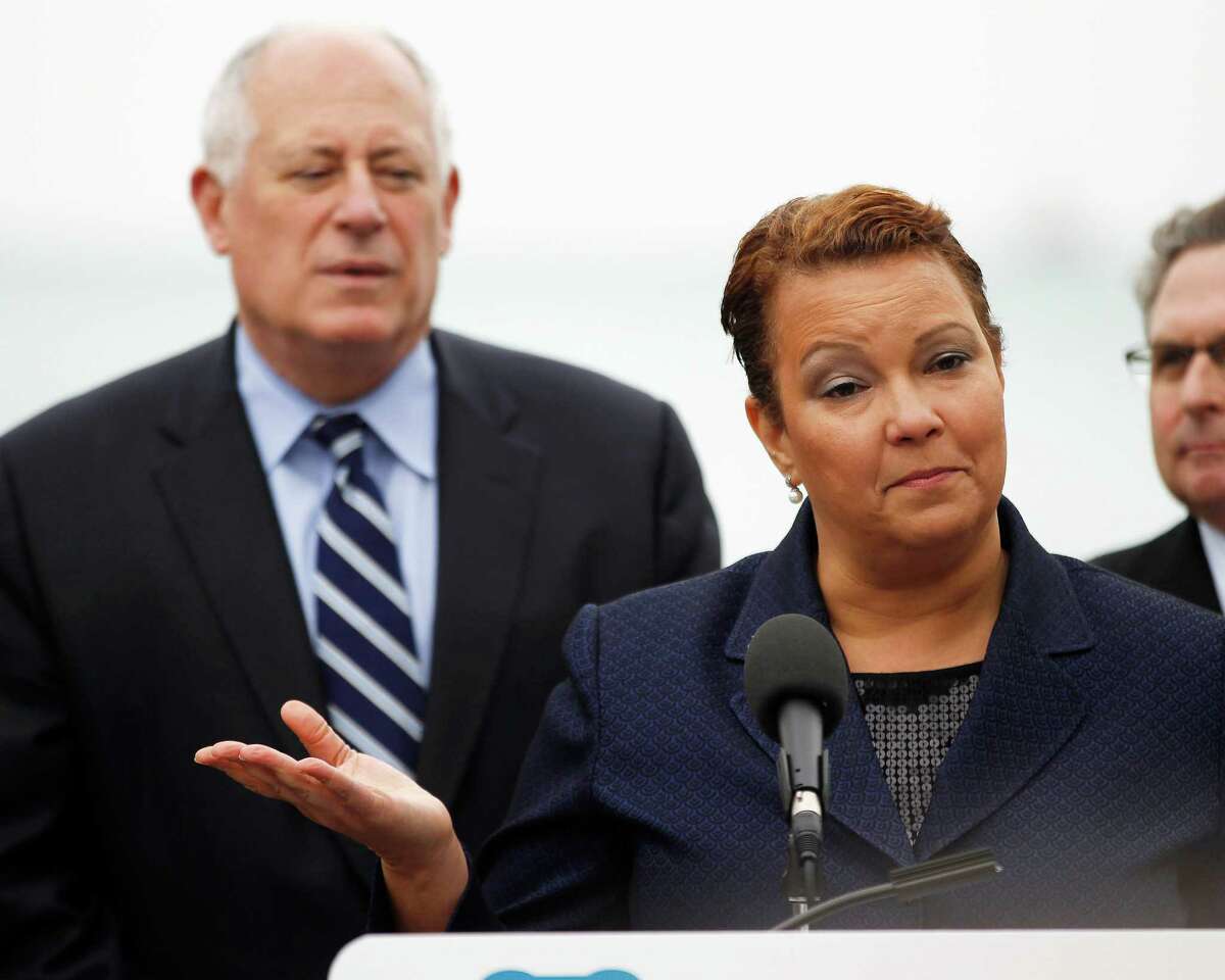 Lisa Jackson, right, administrator of the U.S. Environmental Protection Agency, with Illinois Gov. Pat Quinn looking on, speaks during an event to launch the Illinois Clean Water Initiative at the Shedd Aquarium in Chicago on Thursday, Oct. 18, 2012. The $1 billion initiative is being launched in statewide projects to improve water quality and fix outdated infrastructure such as wastewater treatment plants and sewers.(AP Photo/Chicago Sun-Times, Andrew A. Nelles)