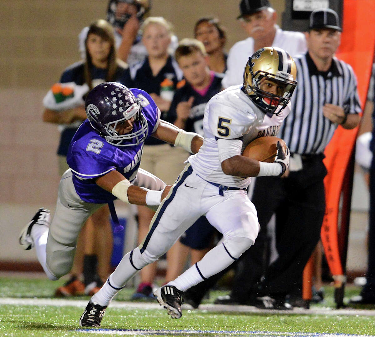 O'Connor's Tre Johnson (5) sprints past Warren's Demonte Butler (2) during a district football game between the Warren Warriors and the o'Connor Panthers at Farris Stadium in San Antonio, Saturday, October 19, 2012. John Albright / Special to the Express-News.
