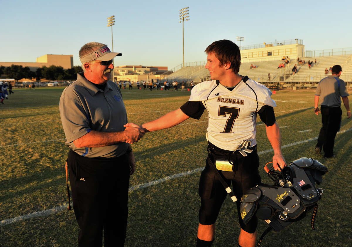 Lanier coach Don Gatian talks with his son Dillon who plays for his opponent, Brennan prior to Friday's game.