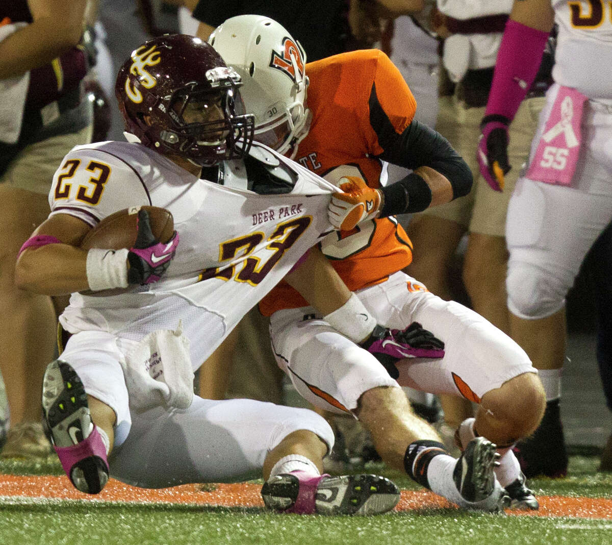 La Porte's Hoza Scott, right, brings down Deer Park running back Noah Cano during first-quarter action at Bulldog Stadium on Friday night. The two reunited on a pivotal fourth-quarter play when Scott turned a Cano fumble into the decisive touchdown.