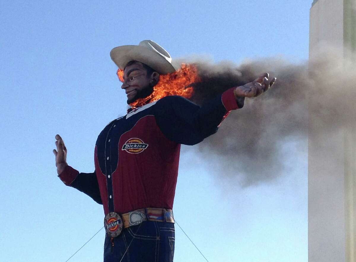 Fire begins to engulf the Big Tex displayed at the State Fair of Texas in Dallas Friday, Oct. 19, 2012. The iconic structure was destroyed Friday when flames engulfed his 52-foot-tall frame.