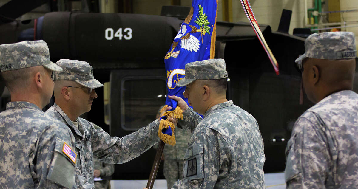 LATHAM, NY -- Lt. Col. Jeffery Baker, the new Battalion Commander of the 3-142nd Assault Helicopter Battalion, receives the Battalion guidon from Col. Mark Stryker, Brigade Commander of the 42nd Combat Aviation Brigade during the Changing of Command of the Battalion from Lt. Col. Mark Slusar to Lt. Col. Jeffery Baker on 7 September, 2012.