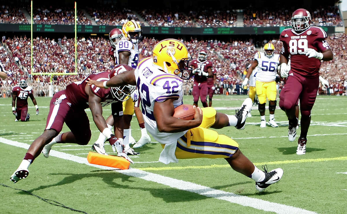 LSU running back Michael Ford (42) gets past the Texas A&M defense on a 20-yard scamper for the first of two Tigers touchdowns in the second quarter Saturday. The A&M defense allowed 219 rushing yards and two TDs on 45 carries.