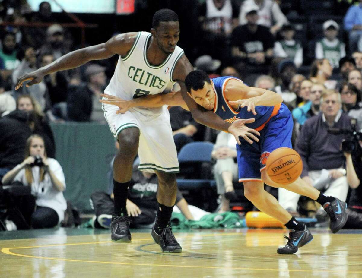 Boston Celtics' Jeff Green (8), knocks the ball away from New York Knicks' Pablo Prigiono, right, during the first half of an NBA preseason game in Albany, N.Y. on Saturday, Oct. 20, 2012. (AP Photo/Tim Roske)