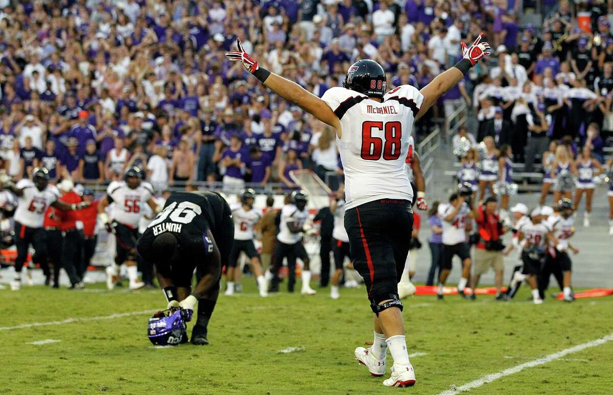 Texas Tech's Terry McDaniel is elated at an outcome Saturday that was rough on TCU's Chucky Hunter, left.