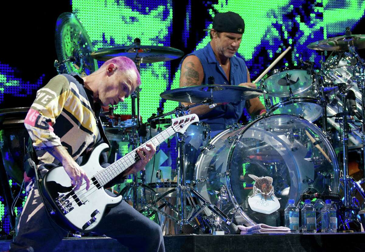 Bassist Flea and drummer Chad Smith of the Red Hot Chili Peppers perform Saturday night at the sold-out Toyota Center in Houston.