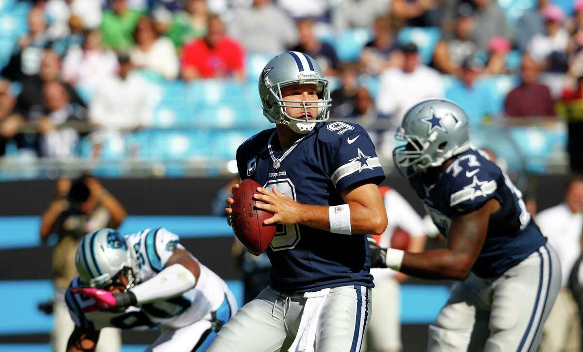 Dallas Cowboys quarterback Tony Romo (9) works against the Carolina Panthers during the second half of an NFL football game, Sunday, Oct. 21, 2012, in Charlotte, N.C. (AP Photo/Chuck Burton)