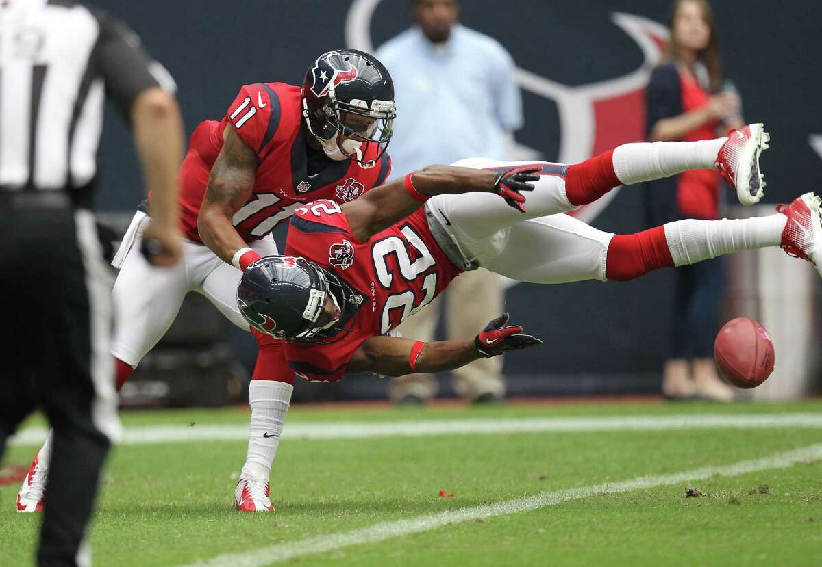 Texans defensive back Alan Ball (22) goes horizontal to down a punt at the 3-yard-line Sunday. Helping Ball on the play is wide receiver DeVier Posey.