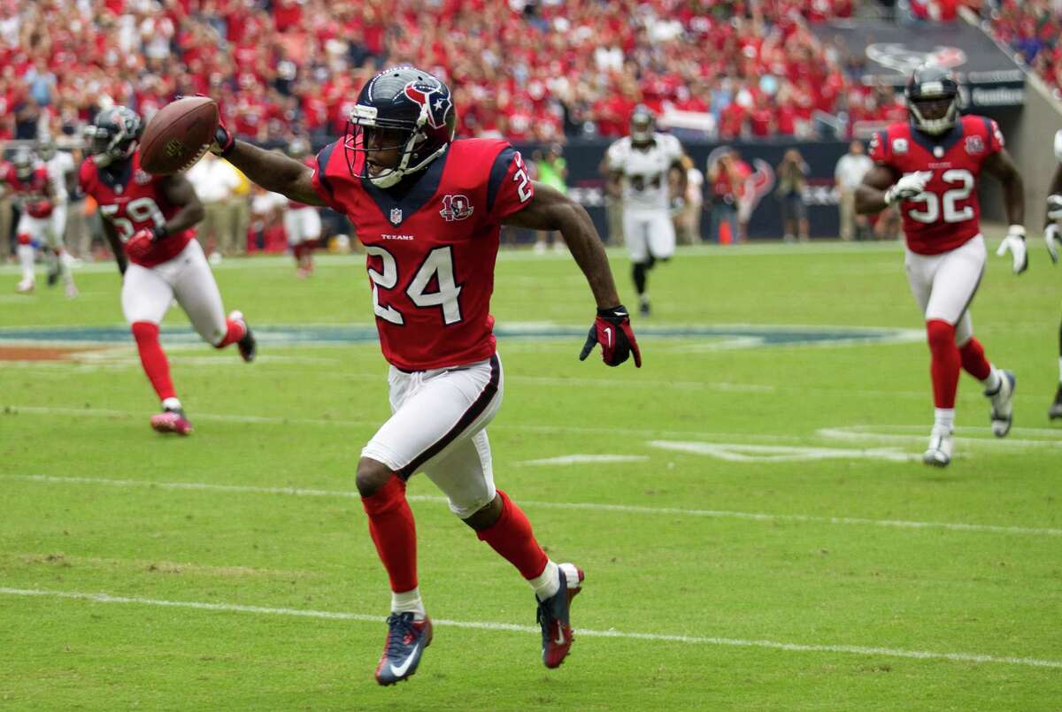 Texans cornerback Johnathan Joseph points the way to pay dirt on his 52-yard interception return for a touchdown.