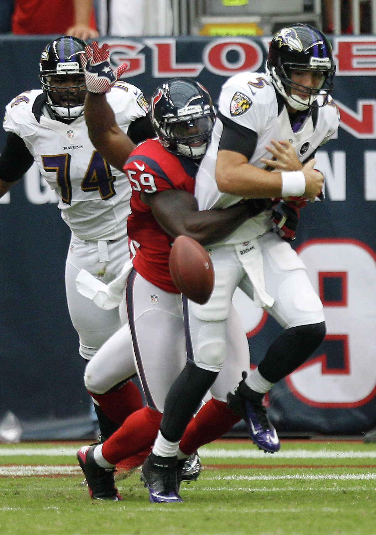 Baltimore Ravens quarterback Joe Flacco (5) gets the ball stripped from him by Houston Texans linebacker Whitney Mercilus (59) during the first quarter at Reliant Stadium on Sunday, Oct. 21, 2012, in Houston. ( Brett Coomer / Houston Chronicle )
