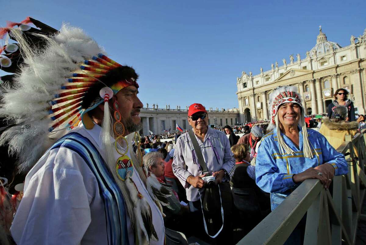 Native Americans wait for the start of a canonization ceremony celebrated by Pope Benedict XVI, in St. Peter's Square, at the Vatican, Sunday, Oct. 21, 2012. The pontiff will canonize seven people, Kateri Tekakwitha, the first Native American saint from the U.S., Maria del Carmen, Pedro Calungsod, Jacques Berthieu, Giovanni Battista Piamarta, Mother Marianne Cope, and Anna Shaeffer. (AP Photo/Andrew Medichini)