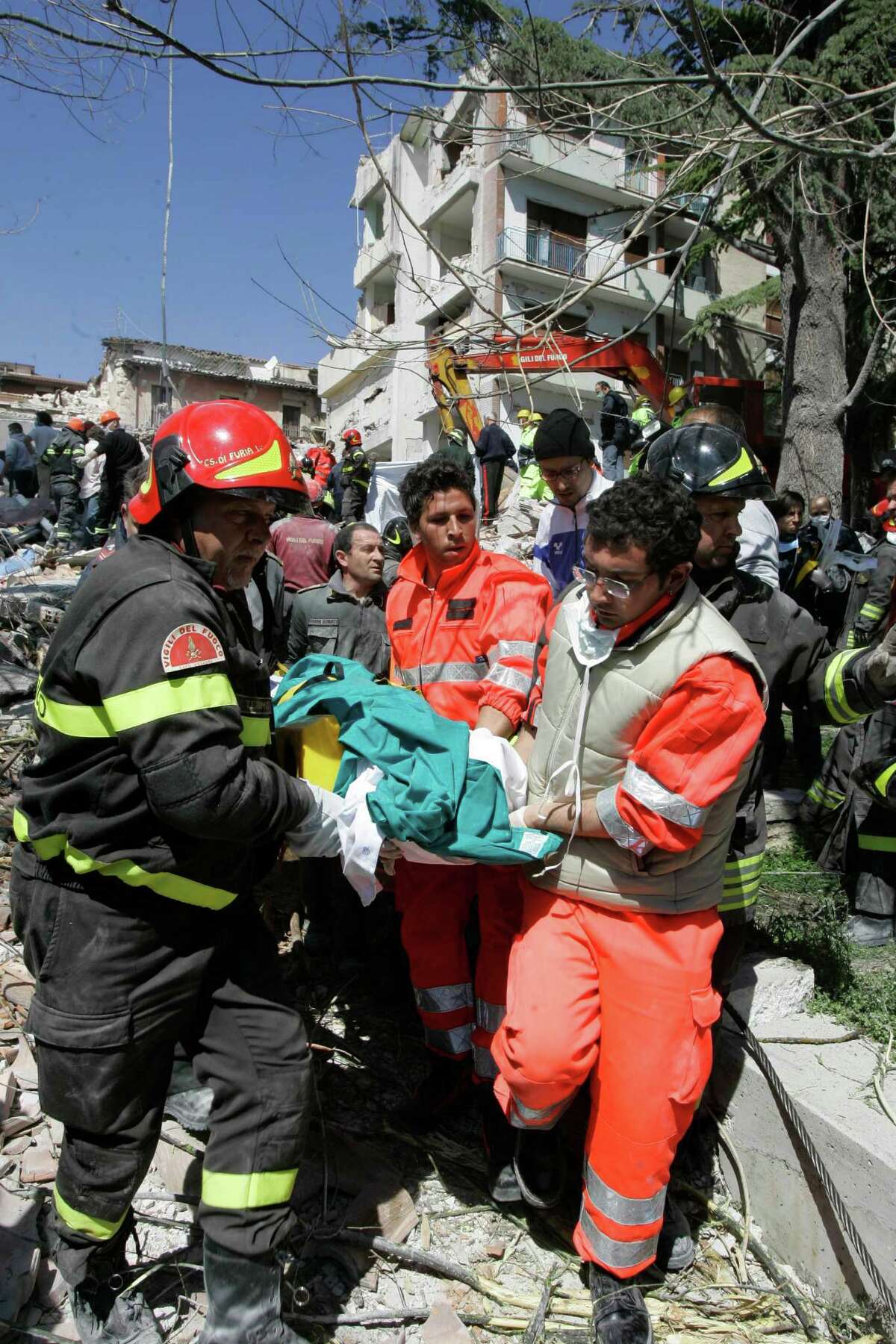 FILE - In this April 6, 2009 file photo Alfredo Gianmaria is carried away by rescuers after a four-storey building collapsed following a earthquake in L'Aquila, central Italy. An Italian court Monday, Oct. 22, 2012 has convicted seven scientists and experts of manslaughter for failing to adequately warn citizens before an earthquake struck central Italy in 2009, killing more than 300 people. The court in L'Aquila Monday evening handed down the convictions and six-year-prison sentences to the defendants, members of a national "Great Risks Commission." In Italy, convictions aren't definitive until after at least one level of appeals, so it is unlikely any of the defendants would face jail immediately. Scientists worldwide had decried the trial as ridiculous, contending that science has no way to predict quakes. (AP Photo/Pier Paolo Cito, File)