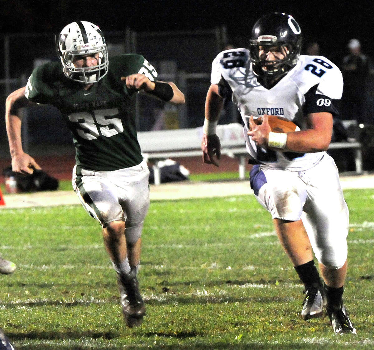Marcus Esteves carries the ball for a touchdown as Oxford plays football at New Milford Monday, Oct. 22, 2012.