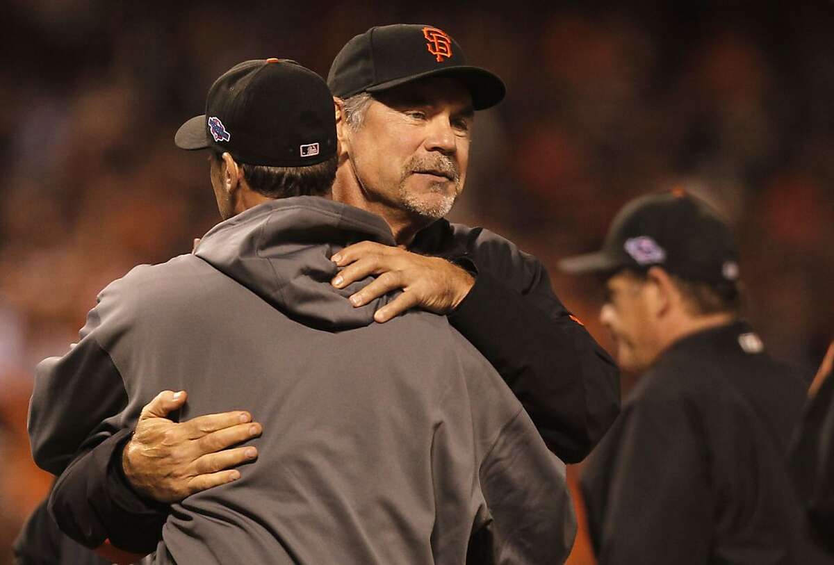 Giants' manager Bruce Bochy, congratulates starting pitcher, Ryan Vogelsong at the end of the game, as the San Francisco beat the St. Louis Cardinals 7-1 in game two, to tie the National League Championship Series at 1-1, at AT&T Park, the San Francisco, Calif., on Monday Oct. 15, 2012.