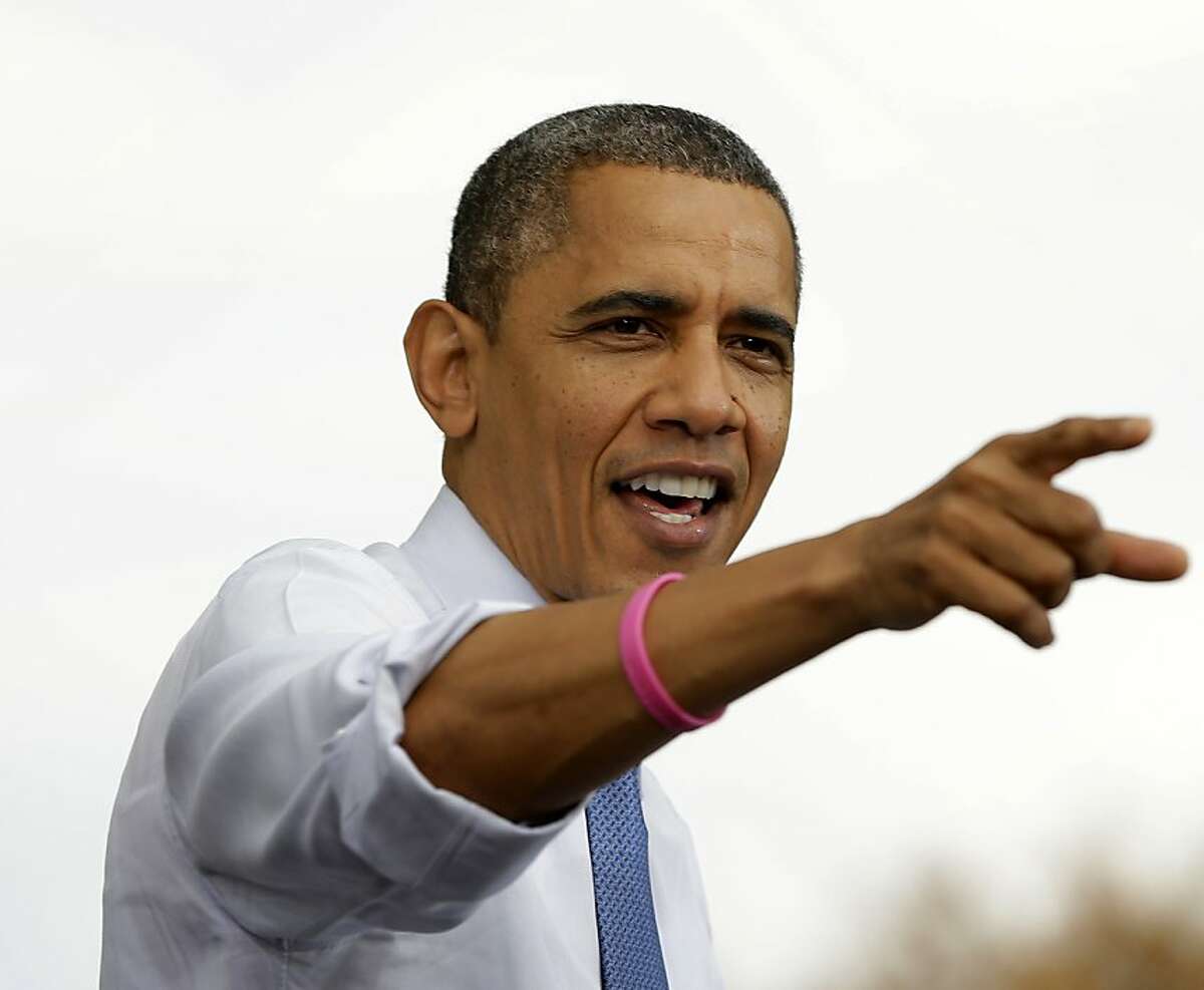 President Barack Obama points to supporters in the audiences as he speaks during a campaign event at the Mississippi Valley Fairgrounds, Wednesday, Oct. 24, 2012, in Davenport, Iowa, as he began a two-day campaign blitz, through eight states with stops in key battleground areas of Iowa, Colorado, Nevada, Ohio and Virginia. (AP Photo/Pablo Martinez Monsivais)