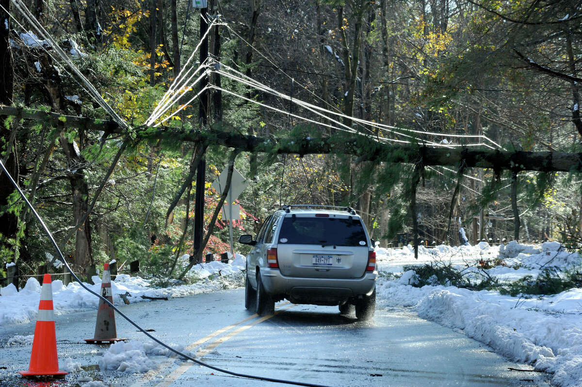 Tree branches rest on wires on Route 37 in Sherman, Conn. on Sunday, Oct. 30, 2011 after a heavy overnight snowfall.