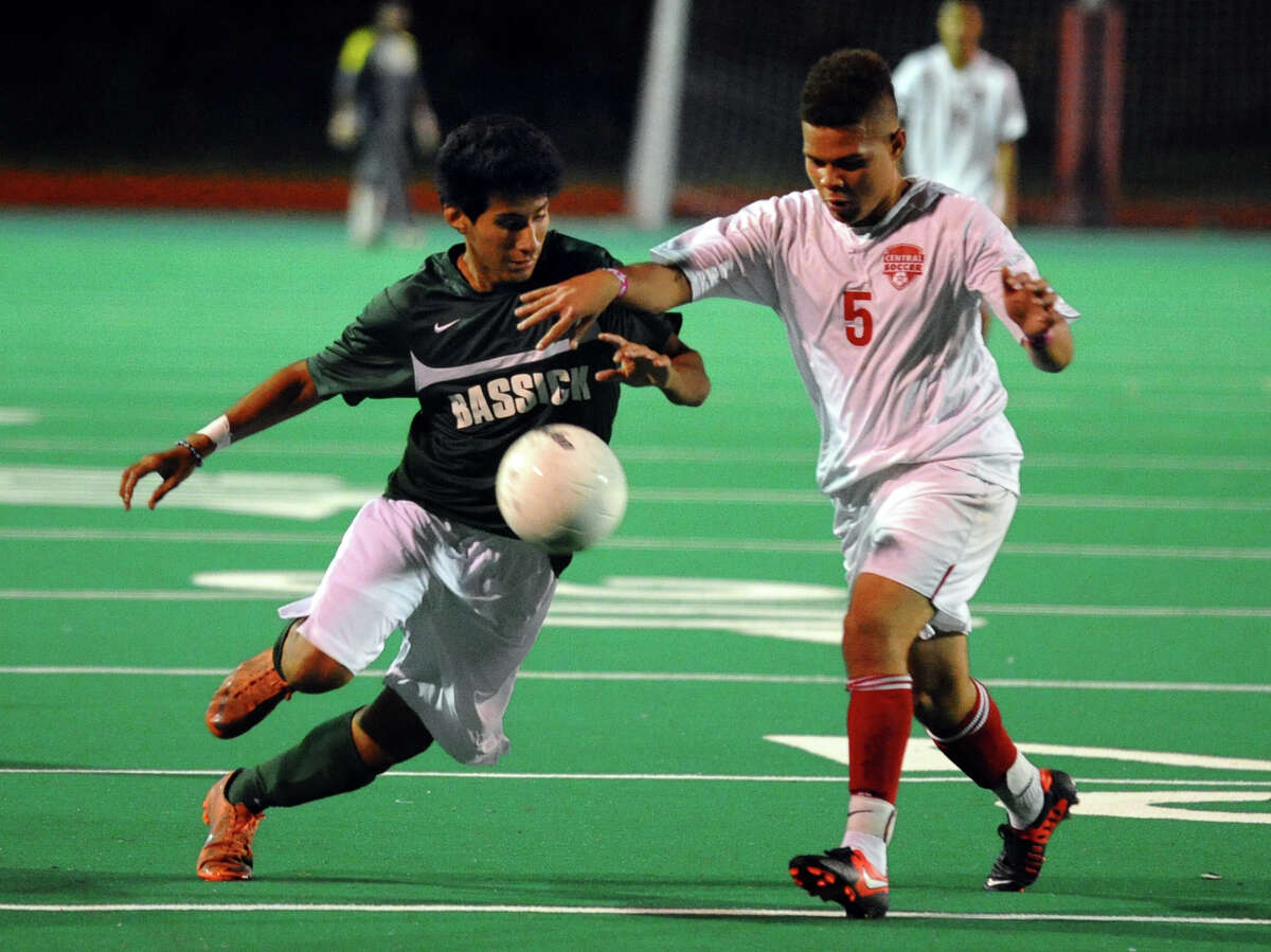 Bassick's #23 Aaron Lopez, left, and Central's #5 Julian Gordon chase down the ball, during boys soccer action in Bridgeport, Conn. on Wednesday October 24, 2012.