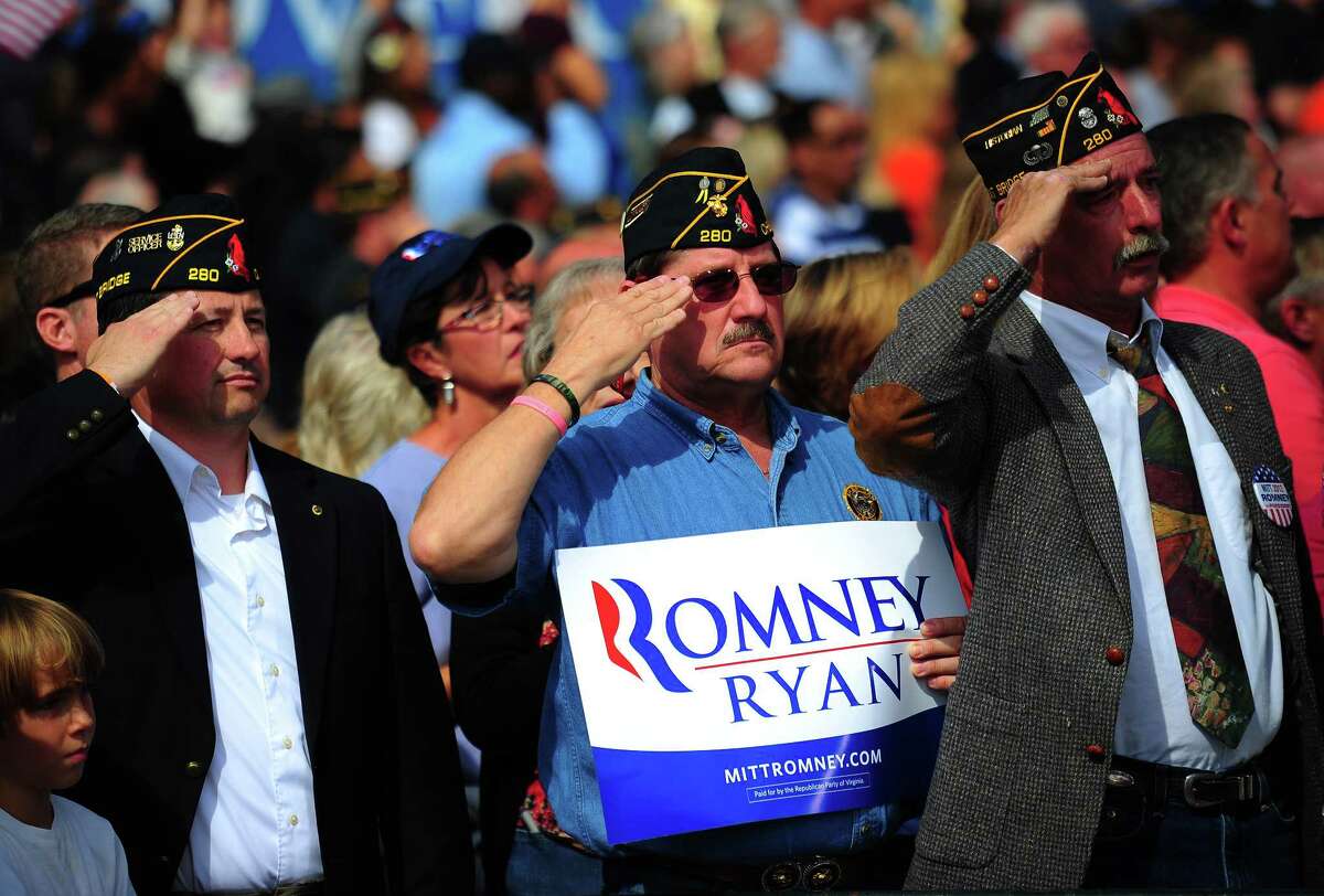(FILES) US military veterans salute while attending a Republican presidential candidate Mitt Romney rally at The Grove, in Chesapeake, Virginia, October 17, 2012. US President Barack Obama and Mitt Romney race through final preparations ahead of their final debate on October 22, 2012, looking to exploit cracks in each other's foreign policy platforms two weeks before an election set to go down to the wire. AFP PHOTO/Emmanuel DUNAND/FILESEMMANUEL DUNAND/AFP/Getty Images